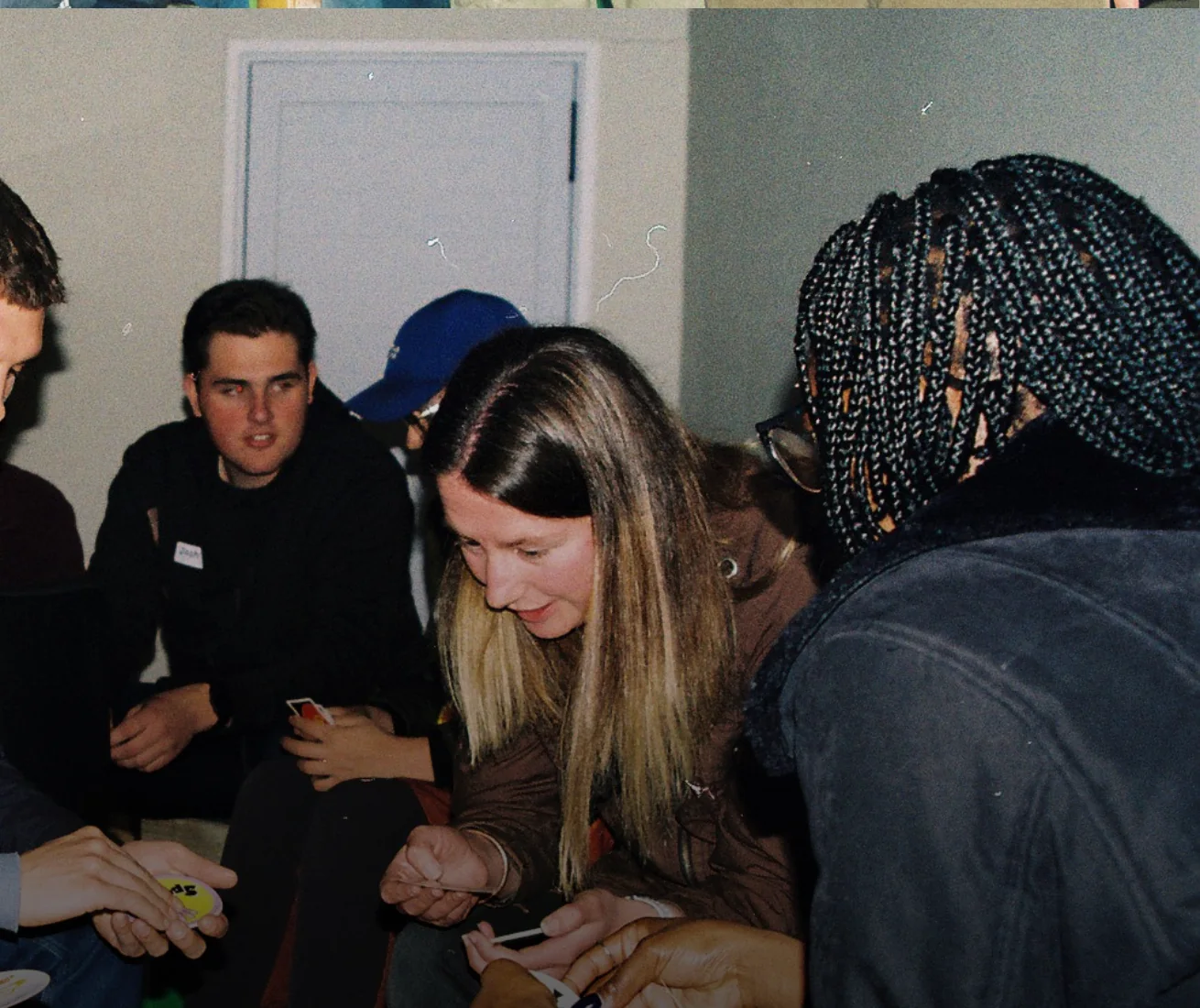 Square Pegs guests sharing a group table game